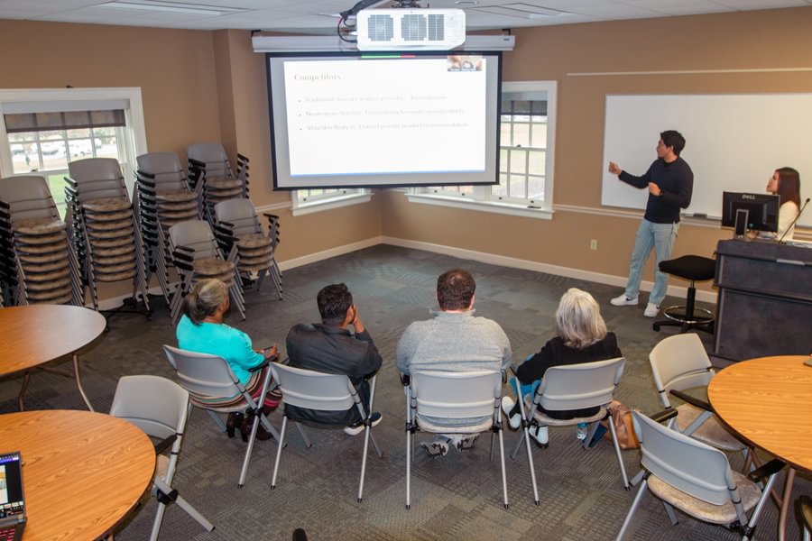 Sanij Shrestha ’26 and Sunny Ho ’27 deliver their proposal to a panel of business professionals