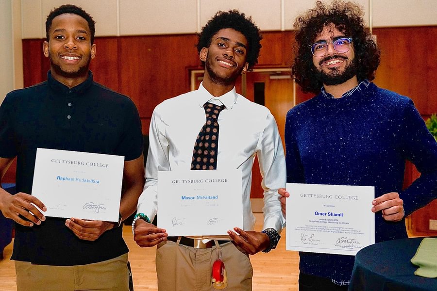 Mason McFarland ’27 celebrates earning a leadership certificate with two classmates.