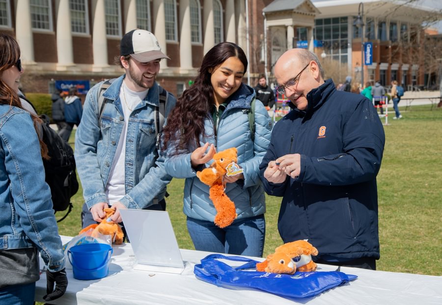 President Iuliano makes plush squirrels with students at Gettysburgives Festival.
