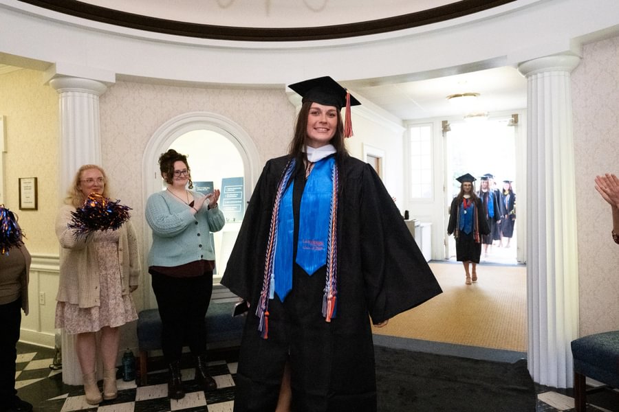 Softball senior Paige Forry walks through Penn Hall after Special Commencement.