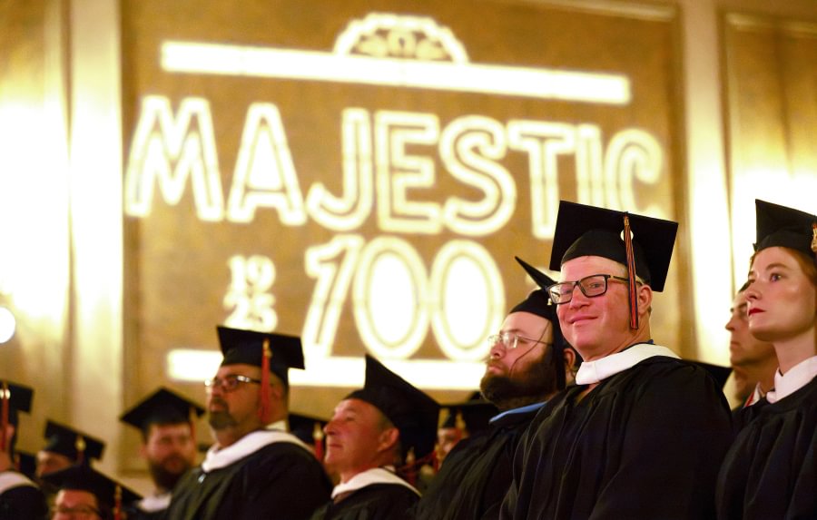 Master's graduates celebrate with family and friends at the Majestic Theater.