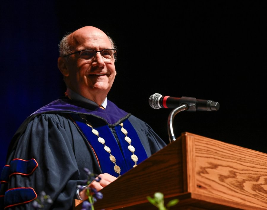 Gettysburg College President Bob Iuliano addresses the master&rsquo;s graduates inside the Majestic Theater.