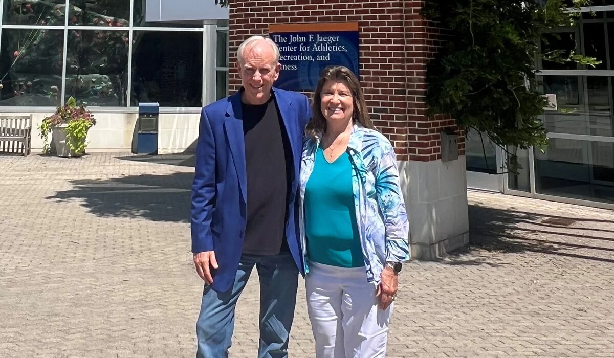 Gordie and Carol Beittenmiller stand in front of The John F. Jaeger Center for Athletics, Recreation, and Fitness.